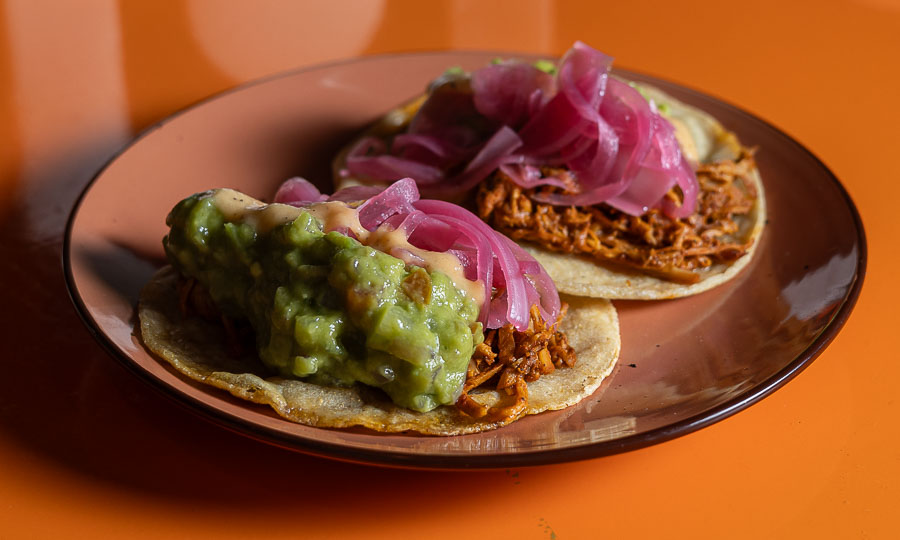 Exitosos tacos Cochinita pibil, con guacamole y cebolla encurtida