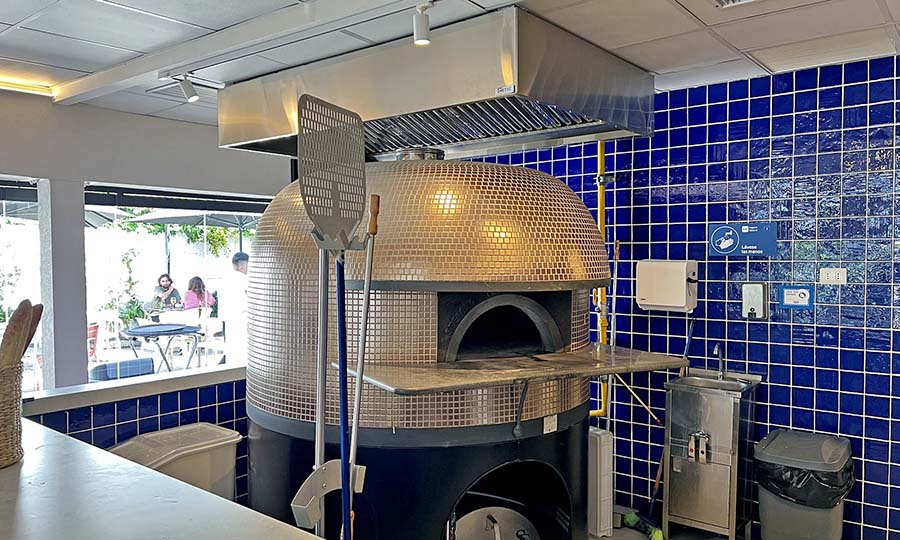 La zona de pizza y cocina de Brunapoli La Reina